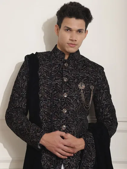 A confident pose in my black patterned Indo-Western sherwani. The detailed fabric and sharp tailoring ensure you look your best from every angle.