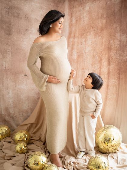 A beautiful moment between a mamma and her son. He is so gentle with her baby bump.