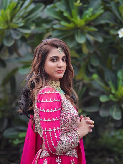 A side profile showcasing the beautiful hairstyle and the way the makeup complements her features and outfit.