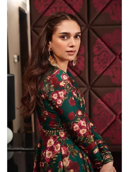 A close-up portrait in the Prints by Radhika set, showing how the floral pattern and statement earrings create a striking look.