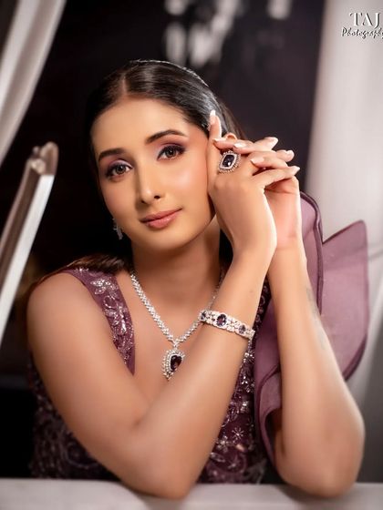 An elegant and poised bridal portrait. The composition and her pose create a sophisticated and timeless image.