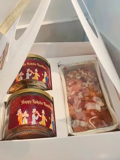 Inside the budget-friendly box: two jars of treats and a loaf of dry fruit cake.