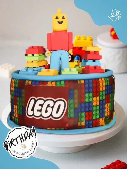 A creative LEGO-themed cake, built with colorful fondant blocks and a LEGO man topper. It's a dream come true for any young master builder.