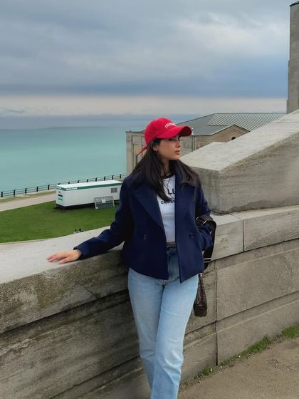 Another angle of the waterside location, showing the full outfit against the scenic backdrop.