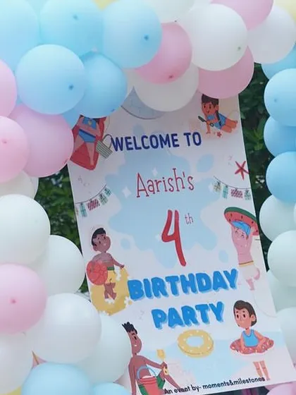 A personalized welcome sign for Aarish's 4th birthday pool party, framed by a pastel balloon arch.