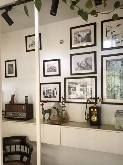 Inside the studio, a bohemian and eclectic style prevails. A gallery wall of my architectural sketches and art is displayed above a vintage Murphy radio and a rotary-style telephone.