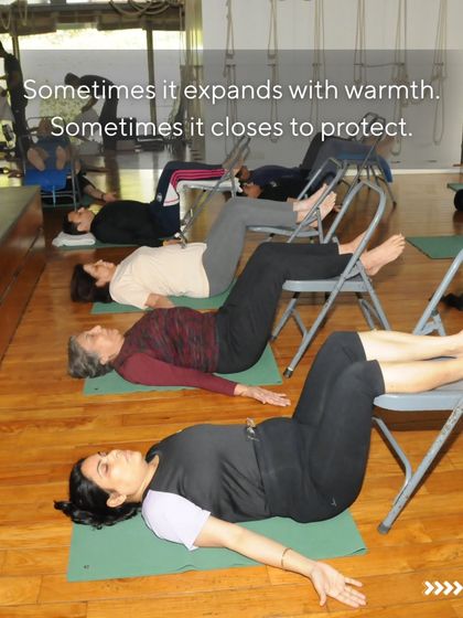 Women in a restorative pose, using chairs to support their legs. This pose is deeply calming and helps to balance the nervous system.
