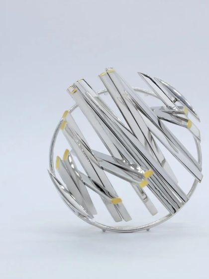 An example of the intricate, abstract designs you can create with silver. This beautiful brooch was crafted by our workshop mentor, showcasing advanced silversmithing techniques.