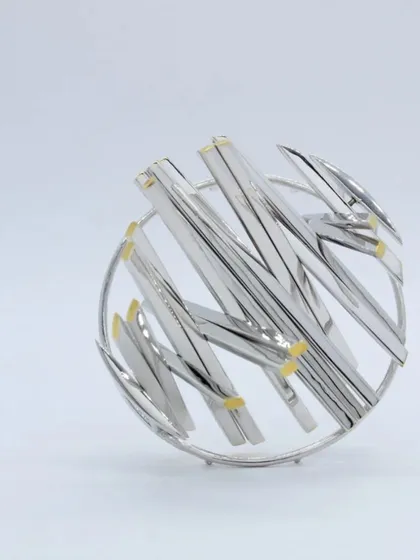 An example of the intricate, abstract designs you can create with silver. This beautiful brooch was crafted by our workshop mentor, showcasing advanced silversmithing techniques.