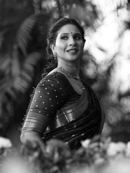 A classic black and white portrait of Shweta, showcasing her natural beauty and the timeless elegance of a saree.