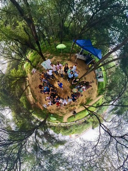 A unique 360-degree "tiny planet" photo of the Fidelity International team gathered at the Aravali Creek site, surrounded by the trees they are helping to grow.