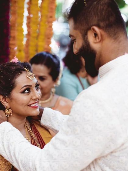 A candid moment of love and connection. The bride's soft, natural makeup allows her happy expression to be the focus.