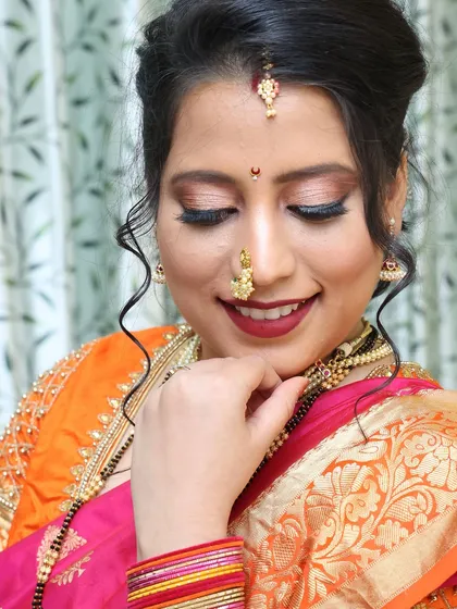 A close-up of a glamorous Marathi bridal look, showcasing the shimmery eye makeup and traditional nose ring.