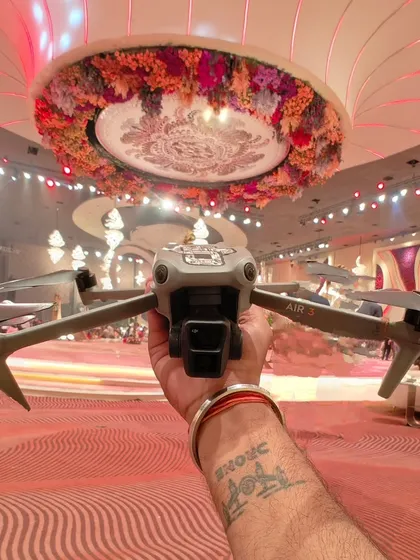 Getting my DJI Air 3 drone ready for an indoor shoot inside a lavishly decorated banquet hall. I am experienced in safely operating my drones in complex indoor environments to get you the perfect shot.