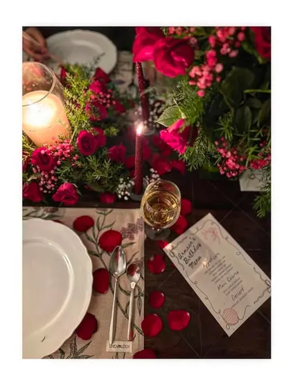 A romantic dinner for two, perfectly set with candles, red roses, and a custom menu. This image highlights our ability to create intimate and unforgettable fine-dining moments.