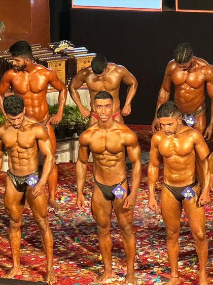 The full lineup of competitors. My client stands out with his conditioning and confident posing.