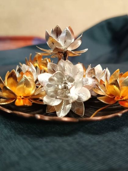 A photo sent by a happy customer, showcasing a gold and silver lotus flower diya set she purchased. Customer happiness is our greatest reward!