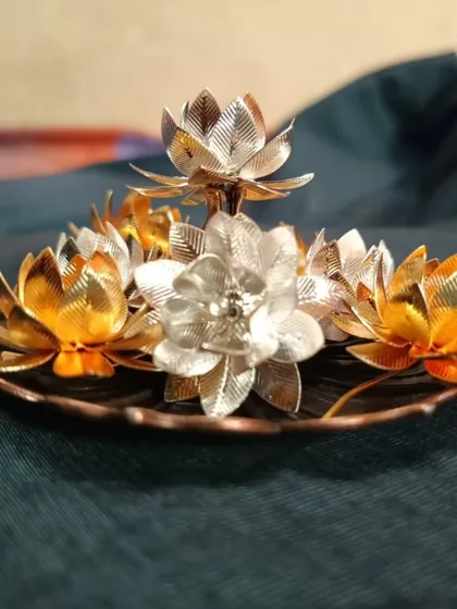 A photo sent by a happy customer, showcasing a gold and silver lotus flower diya set she purchased. Customer happiness is our greatest reward!