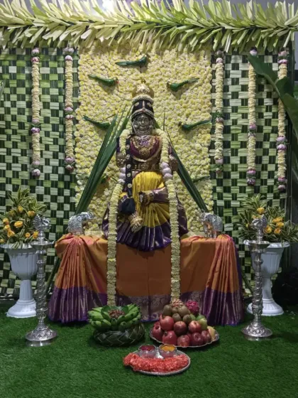 I specialize in decorations for religious festivals like Varamahalakshmi puja. This setup includes a backdrop of traditionally woven coconut leaves and a decorated mantap for the goddess.