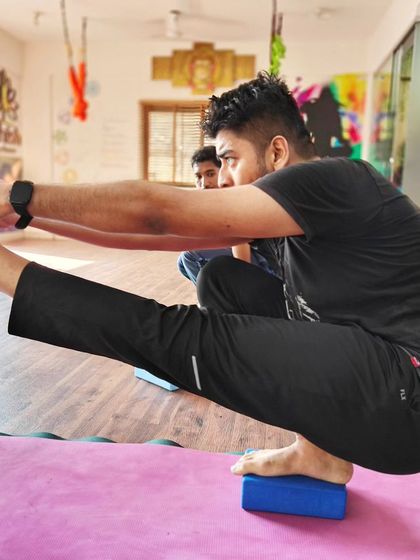 A student practices a single-leg balance on a block, a great preparation for more advanced standing poses.