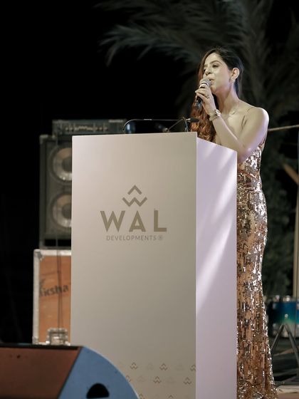 A close-up at the WAL Developments podium, mid-speech.