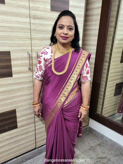 A full-length photo of the Mysore silk saree drape. It's a simple, elegant, and professional look suitable for any formal occasion.