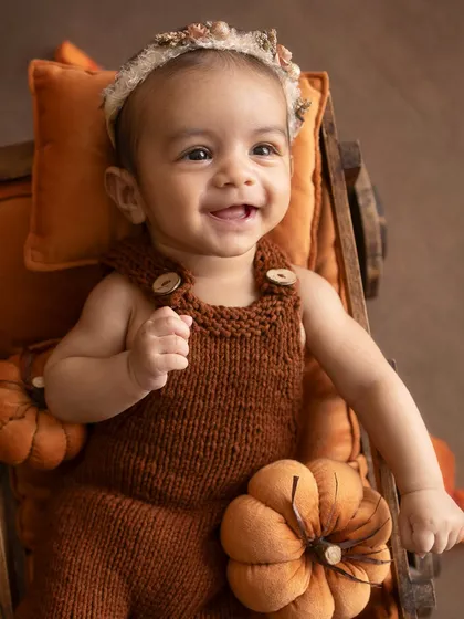 A big, gummy smile from the 3-month-old baby.