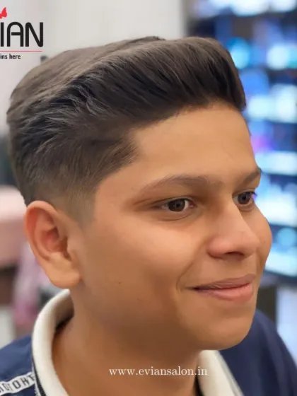 A great haircut can make you feel fantastic. This young man's smile shows his confidence in his fresh, new style.