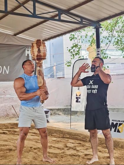 Our founder coaching an athlete in a traditional sandpit akhada. This image shows our commitment to learning from the source and sharing the authentic techniques of Indian strength training with the world.