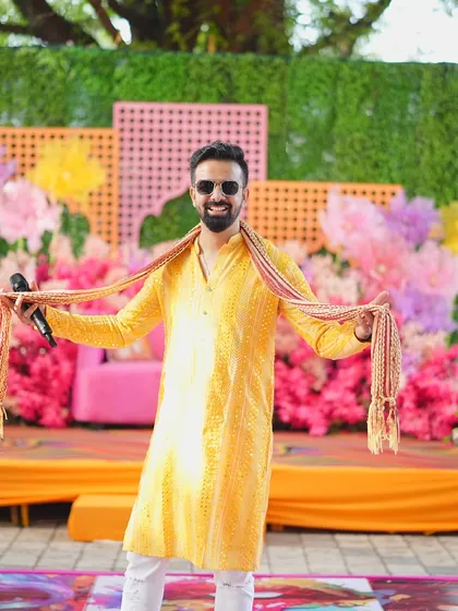 Posing on the colorful stage before the Haldi festivities begin. The vibrant decor set the tone for a fun-filled event.