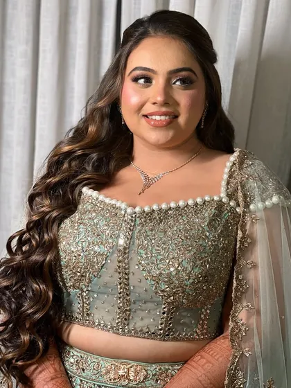 A final portrait of the Sangeet bride. The voluminous waves and polished finish make this a truly show-stopping look.