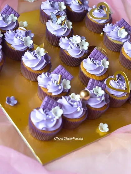 A closer look at the details on my purple heart-shaped cupcake arrangement. You can see the different toppers used, including hearts, stars, and butterflies.