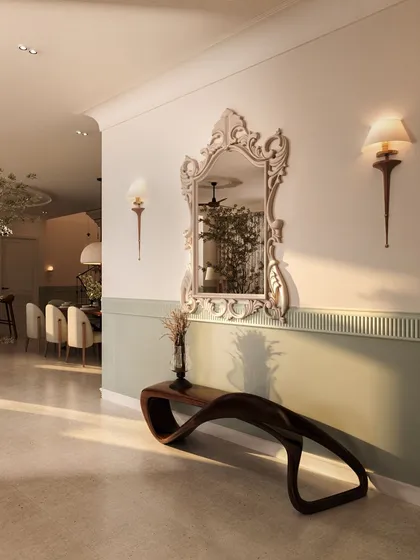 The entry foyer of this penthouse sets a dramatic tone with a two-toned green and white wall, a striking classical mirror, and a sculptural wooden bench. It's a grand welcome that hints at the home's blend of modern and classical styles.