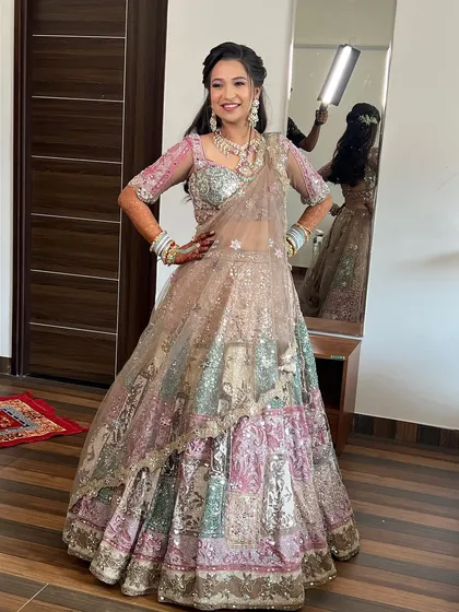 A full-length shot of the bride, showing off the unique and colorful lehenga.