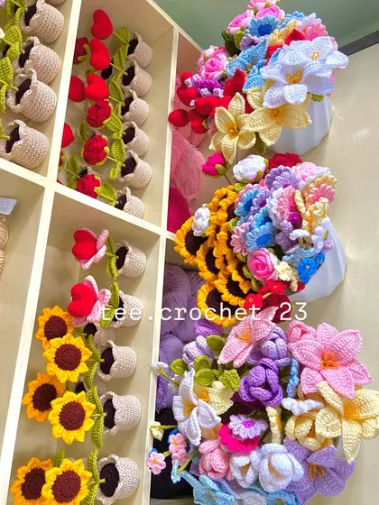An angled shot of my shelves, showing how I organize different types of potted flowers and bouquets.