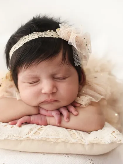 The quiet perfection of a newborn. I focus on capturing those tiny, delicate features, like the curve of their cheek and the peacefulness of their sleep. This classic head-on-hands pose is a timeless way to remember just how small they once were.