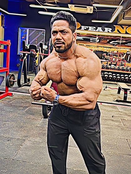 Top of the game. A most muscular pose showing the chest and arm development.