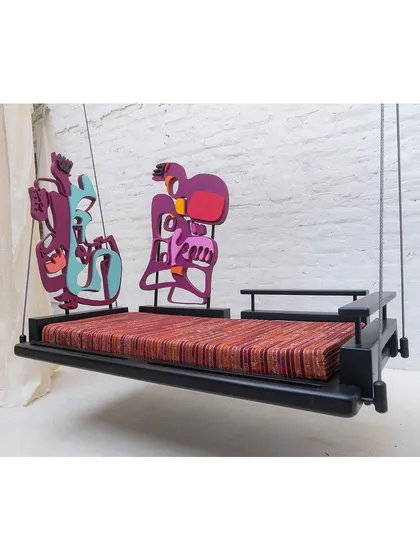 A side profile of the swing, showing how the two distinct, colorful art pieces serve as functional backrests, creating a dynamic and unconventional silhouette.