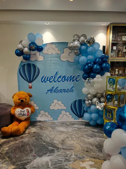 The personalized backdrop and balloon arch create a perfect spot for family photos.