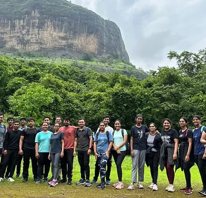 The group at the start of the Devkund Waterfall trek, with the unique landscape of the region behind them.