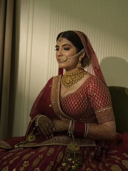 It was so special getting my own sister ready for her big day. Here she is, looking serene and beautiful in her classic red lehenga with timeless gold jewelry.