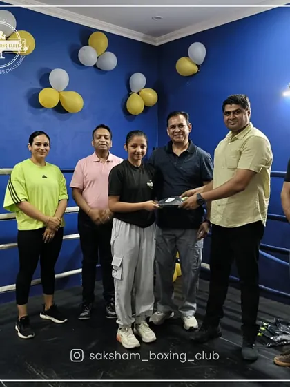 Celebrating the success of our boxers. Here, one of our dedicated female students is recognized for her hard work and progress in the ring.