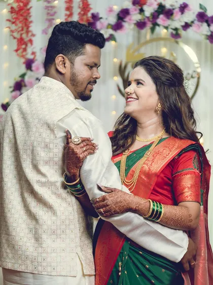 A candid, smiling interaction between the couple during their engagement ceremony.