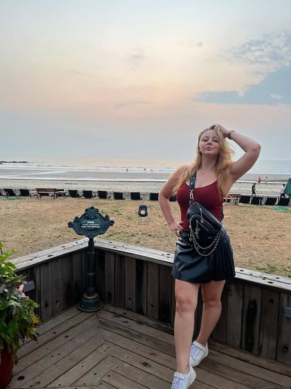 A relaxed photo on a balcony overlooking the beach in Goa, capturing the beautiful sunset vibe of my home base.