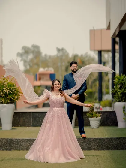 Capturing the uninhibited joy of your special day is what we do best. The bride's playful spirit shines as her veil catches the wind, creating a dynamic and candid photograph that is full of life and happiness.