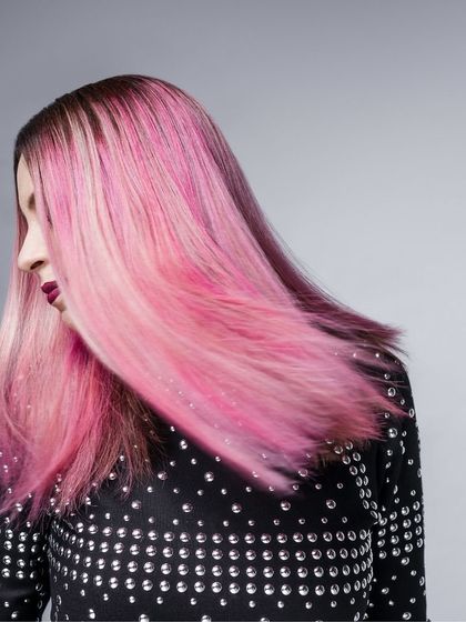 A shot from my work with musician Bianca Gomes of Shor Police. The movement in her vibrant pink hair is the focus, complemented by a studded black top that adds a bit of edge. This styling captures her dynamic energy as an artist.