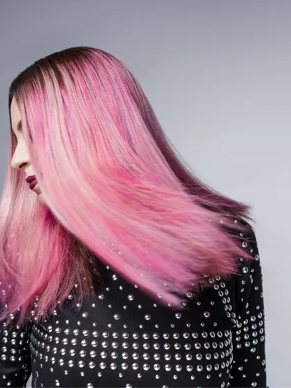 A shot from my work with musician Bianca Gomes of Shor Police. The movement in her vibrant pink hair is the focus, complemented by a studded black top that adds a bit of edge. This styling captures her dynamic energy as an artist.