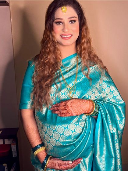 The full look, showcasing the beautiful saree and the glowing makeup.