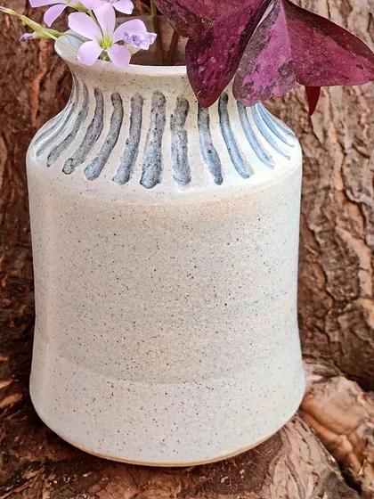 This beautiful, speckled vase was handcrafted by a student on the potter's wheel. It’s a testament to how, with a little patience and guidance, you can create functional art for your home that is completely unique to you.