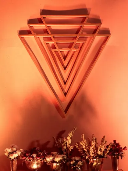 The downward-pointing triangles of the Shri Yantra, symbolizing Shakti or creative power, are used here as a striking wall art piece.